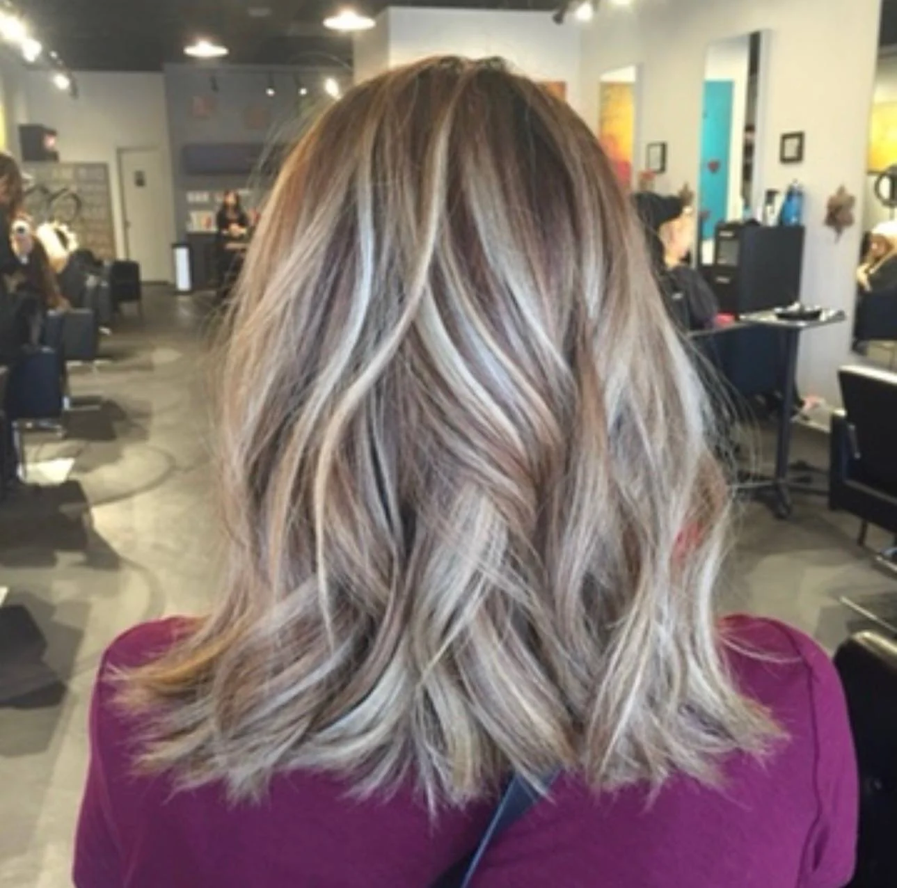 Dimensional lived-in blonde color and soft waves created by Elizabeth